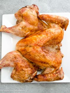 the whole chicken is sitting on a white platter and ready to be cooked in the oven