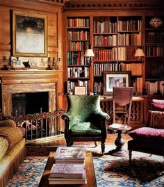 a living room filled with lots of books and furniture