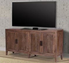 a flat screen tv sitting on top of a wooden cabinet