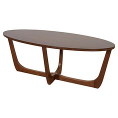 an oval wooden table with curved legs