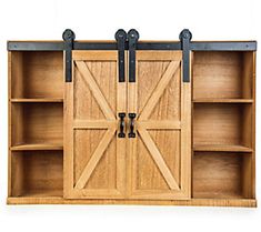 a wooden bookcase with sliding doors on the front and back sides, open to reveal a barn door