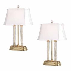 a pair of lamps sitting on top of a white table next to eachother