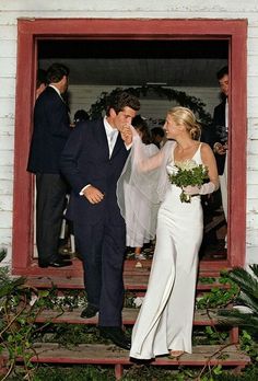 the bride and groom are walking out of the door to greet each other at their wedding