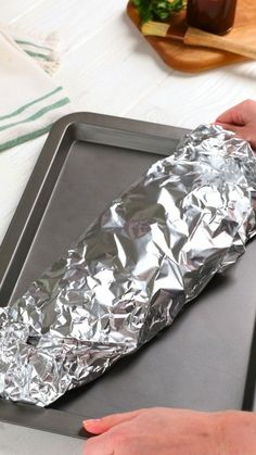 a person is making something out of aluminum foil