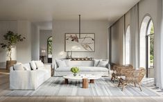 a living room filled with white furniture and lots of wood flooring next to windows