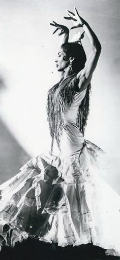 a woman in a long dress is dancing