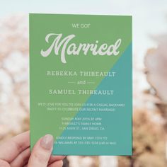 a person holding up a green and white card with the words married written on it