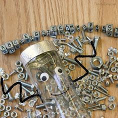 a jar filled with lots of screws and nuts on top of a wooden table