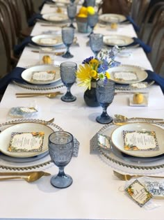 a long table set with plates and silverware