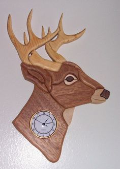 a clock mounted to the side of a wooden deer head