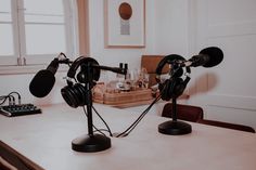 two microphones sitting on top of a table next to an old fashioned radio set