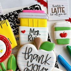 decorated cookies with thank you notes and school supplies on top of each cookie, including an apple