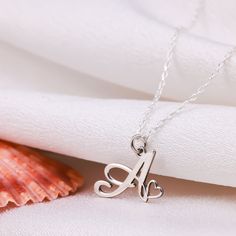 The Handmade Letter Necklace gold, which we offer in 925 Sterling Silver or 14 Karat Gold, is the perfect gift for Mothers Day. The 14K solid version of the letter necklace gift also comes with a 14K solid gold chain. This handmade tiny letter necklace is Silver or gold and perfect Made with quality.  PRODUCT HIGHLIGHTS  Made of high quality 925 Sterling Silver or 14K Solid Gold Necklaces for Women. You can personalize this silver necklace with your or your loved ones' names. For further customi Anniversary Necklace With Initial Pendant And Hallmarks, Dainty Sterling Silver Initial Necklace For Anniversary, White Gold Necklaces With Hallmarks For Anniversary Gift, White Gold Initial Pendant Necklace As Gift, Sterling Silver Hallmark Necklace For Birthday, Valentine's Day Anniversary Gift Hallmarked Necklace, Sterling Silver Initial Pendant Charm Necklace For Anniversary, Silver Initial Necklace For Valentine's Anniversary, Sterling Silver Initial Necklaces For Anniversary Gift