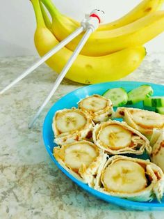 there are bananas and cucumbers on the plate next to each other with chopsticks