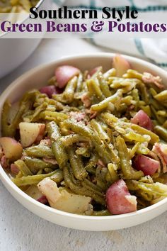 a white bowl filled with green beans and potatoes