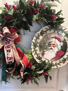 two christmas wreaths are hanging on the front door