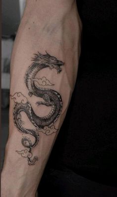 a man with a dragon tattoo on his arm