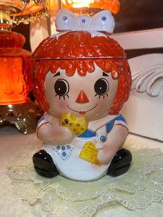 a ceramic doll sitting on top of a table