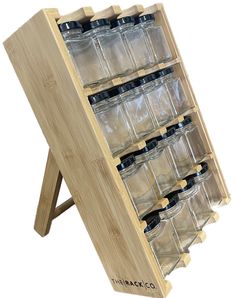 a wooden display case with six glass bottles in it