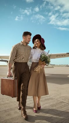 a man and woman are walking on the tarmac with suitcases in their hands