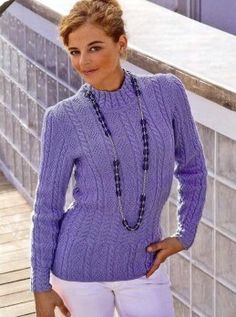 a woman wearing a purple sweater and white pants