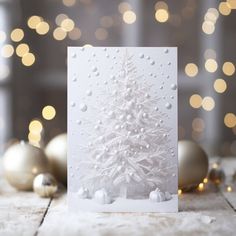 a white christmas tree card on a table