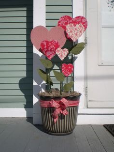 a potted plant with paper hearts on it