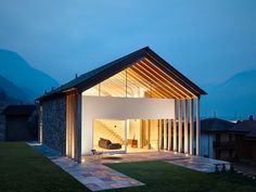 a modern house is lit up at night