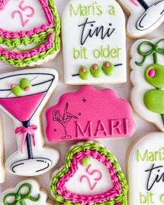 decorated cookies are arranged in the shape of martinis and cocktail glasses with words on them