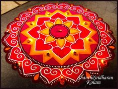 a red and yellow decorated table with lights on it's sides in the shape of a flower