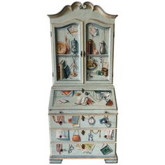 an old dresser with many items painted on the top and bottom drawers, all in different colors