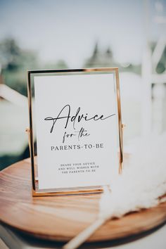 a sign that says advice for the parents to be on top of a wooden table