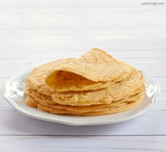 a stack of pancakes sitting on top of a white plate