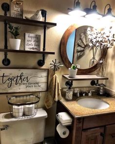 a bathroom with a toilet, sink and shelf above it is decorated in rustic style