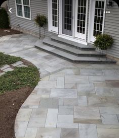 an outdoor patio with steps leading to the front door