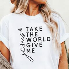 Showcase your devotion with our Take the World, Give Me Jesus shirt. Featuring the powerful message "Take the World, Give Me Jesus" in bold, modern lettering, this shirt is perfect for those who prioritize their faith above all else. Ideal for casual wear or as a thoughtful gift for friends and family who share your beliefs. Jeses Shirts, White Inspirational Everyday T-shirt, Trust Jesus Shirt, Faith Based Shirts For Women, Jesus Saved My Life Shirt, Modern Lettering, Jesus Tshirts, Give Me Jesus, Inspirational Tees