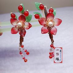 Product description Name -A Pair Of Handmade Vibrant Red Flower Hair Clip With Dangle , Chinese Hanfu Hair Clips, Asian Hanfu Bridal , Hair Accessories Material Used - Copper, Glass Beads, Acrylic Pearl Color -Red + Gold Size - 1.6  X 2.3 Inches + Tassel 2 Inches  Weight -2 OZ What is inside the shipping box - A Pair of Hair Clip Now, "LEAVE YOUR MESSAGE" service is available for free.  Simply just leave what you want to say in the gift message section when checking out or email it to me.   I wi Hanfu Hair, Copper Glass, Chinese Hanfu, Flower Hair Clip, Indigenous Culture, Gift Message, Flower Hair Clips, Hair Sticks, Red Flower