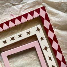 three wooden frames with stars painted on them