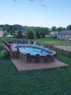 an above ground pool surrounded by wooden decking