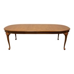 an oval wooden table with two leaves on the top