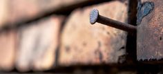 an old rusted metal door with nails on it