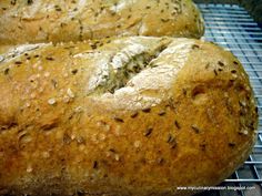 two loaves of bread cooling on a rack