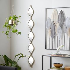 a living room filled with lots of furniture next to a wall mounted art piece on the wall