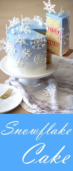 there is a cake on the table with snowflakes on it and one slice has been taken out