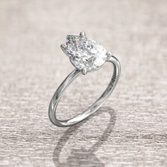 a diamond engagement ring on a wooden surface