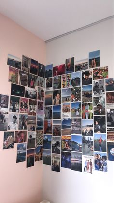 a wall with many pictures on it and a bed in front of the wall is white