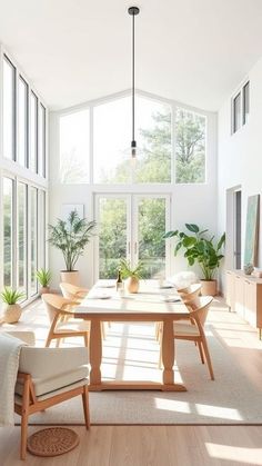 a dining room table and chairs in front of large windows with potted plants on them