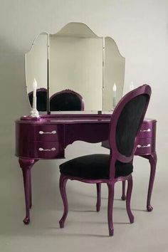 a purple vanity with a mirror and chair