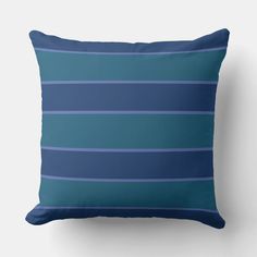 a blue striped pillow on a white wall