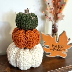 three knitted pumpkins sitting on top of each other